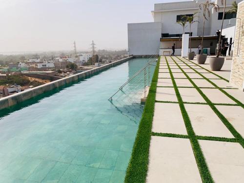 a swimming pool on the roof of a building at Appartement haut standing avec piscine in Dakar