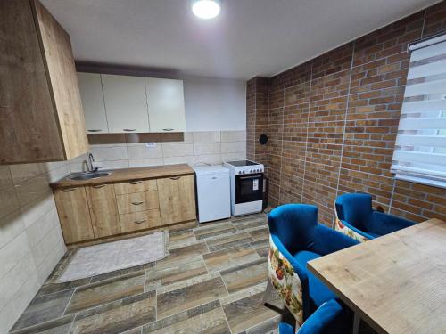 a kitchen with a sink and a stove top oven at City View Apartment in Bijelo Polje