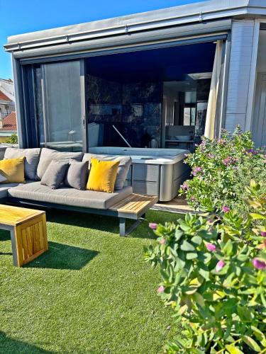 a living room with a couch in a yard at Villa Olivetta heritage residence in Crikvenica