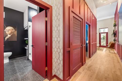 a hallway with red doors in a house at Geranium Giant Close Proximity To Piedmont Park in Atlanta