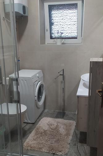a bathroom with a washing machine and a sink at Apartments by the sea Medveja, Opatija - 7722 in Lovran