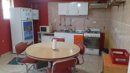 Departamentos La chacra في ريو جاليجوس: مطبخ مع طاولة خشبية وطاولة وكراسي