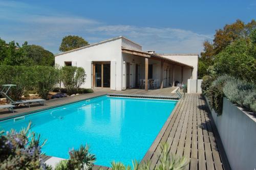 a swimming pool in front of a house at Villa Coucou Les Amis in Sainte-Lucie de Porto-Vecchio