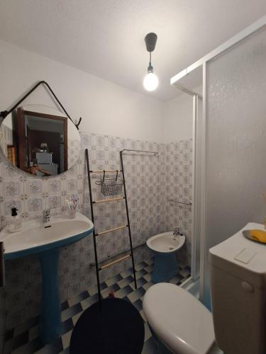 a bathroom with a sink and a toilet and a mirror at Casa Terreiro Da Lapa in Quintela