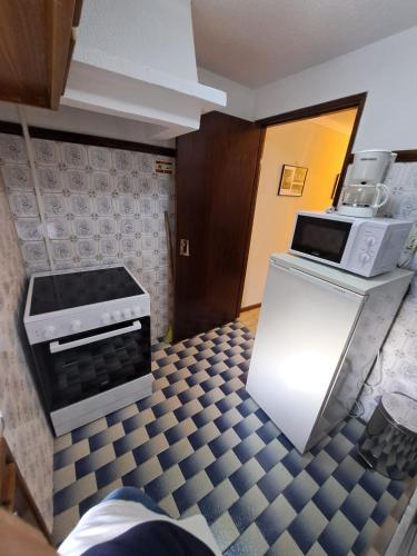 a kitchen with a stove and a microwave at Casa Terreiro Da Lapa in Quintela