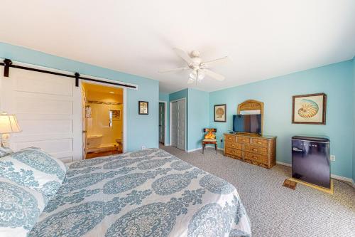 a bedroom with a bed and a ceiling fan at Sandcastle #6F in Dauphin Island