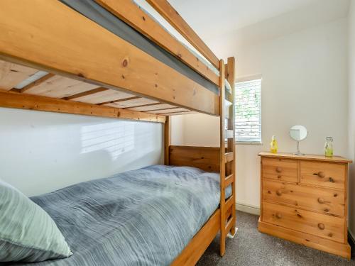 a bedroom with a bunk bed and a dresser at Lakeview Cottage - Uk44099 in Carsington