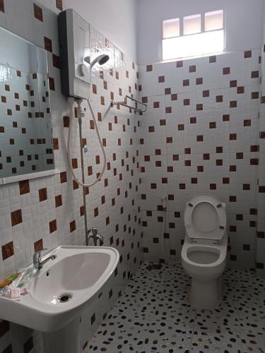 a bathroom with a toilet and a sink at Orchid 101 in Kampot