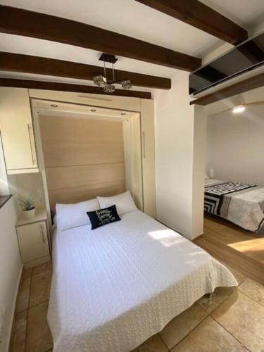 a bedroom with a white bed in a room at Casa Vera-Playa in Vera