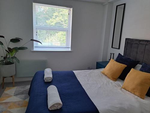 a bedroom with a large bed with towels on it at Modern city house in Southampton