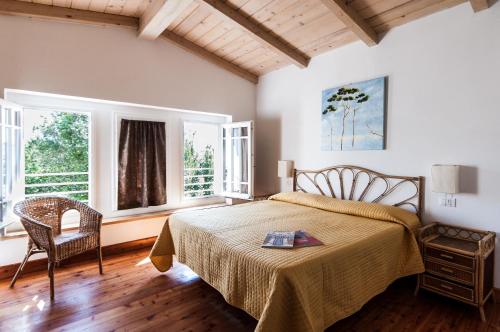 a bedroom with a bed and two windows at Hotel Club i Pini - Residenza d'Epoca in Versilia in Lido di Camaiore
