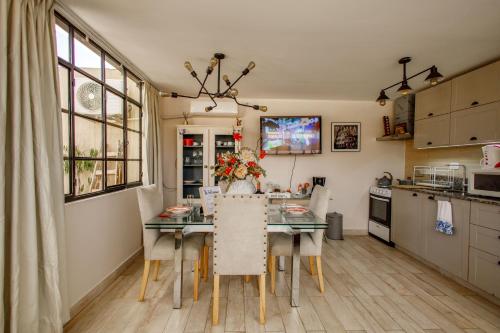a kitchen with a dining room table with chairs at REGINA HOME in San Salvador de Jujuy