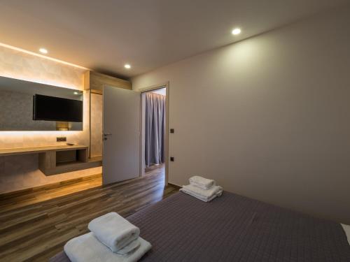 a bedroom with a bed with towels on it at Paradise Resort in Finikounta
