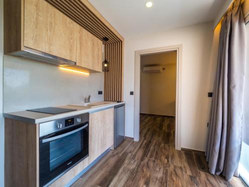 a kitchen with a sink and a stove top oven at Paradise Resort in Finikounta