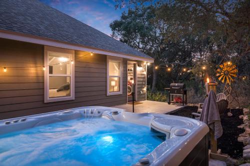 a hot tub in front of a house at The Overlook Cottage . King Bed . Mini Lake View in Canyon Lake