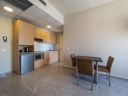 a kitchen and dining room with a table and chairs at Paradise Resort in Finikounta