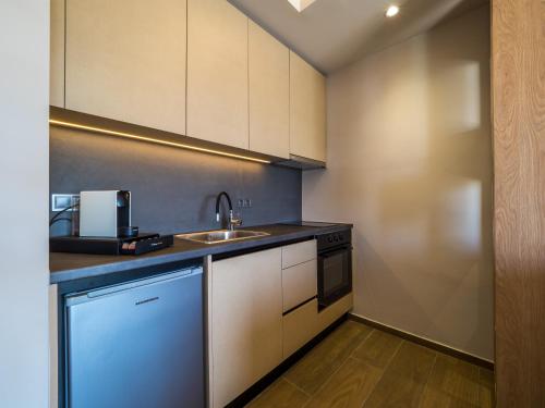 a kitchen with a sink and a counter top at Paradise Resort in Finikounta