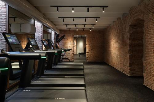 a row of tables in a room with brick walls at JW Marriott Hotel Madrid in Madrid