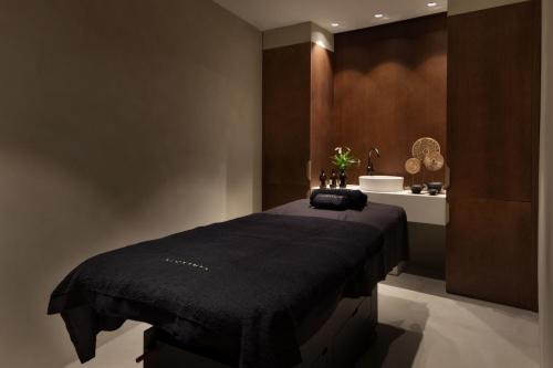 a bedroom with a bed with a black blanket at JW Marriott Hotel Madrid in Madrid