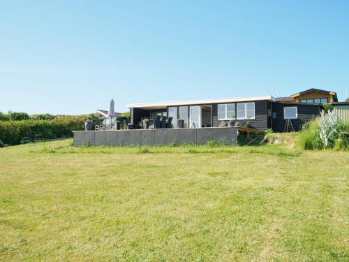 a house with a large yard in front of it at 4 person holiday home in Slagelse-By Traum in Slagelse