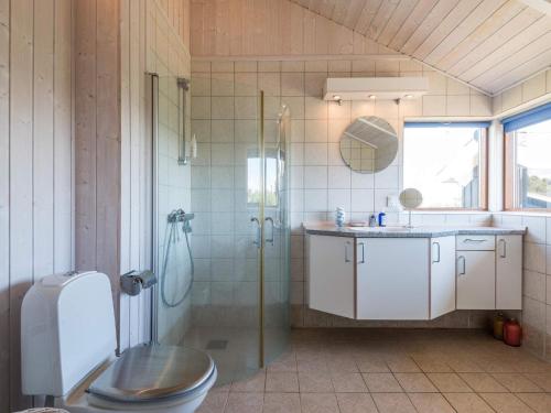 a bathroom with a shower and a toilet and a sink at Holiday home Fanø VII in Fanø