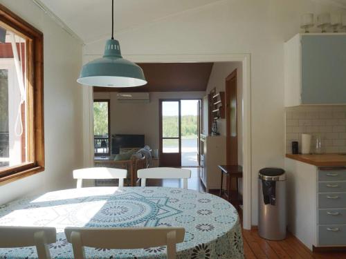 a kitchen and dining room with a table and chairs at 6 person holiday home in ÅKERSBERGA-By Traum in Åkersberga