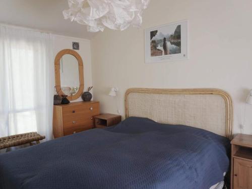 a bedroom with a bed and a dresser and a mirror at 6 person holiday home in ÅKERSBERGA-By Traum in Åkersberga