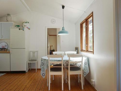 a kitchen with a table and chairs and a refrigerator at 6 person holiday home in ÅKERSBERGA-By Traum in Åkersberga