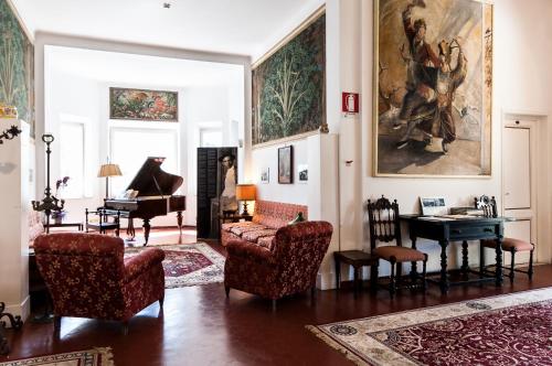 a living room filled with furniture and a piano at Hotel Club i Pini - Residenza d'Epoca in Versilia in Lido di Camaiore
