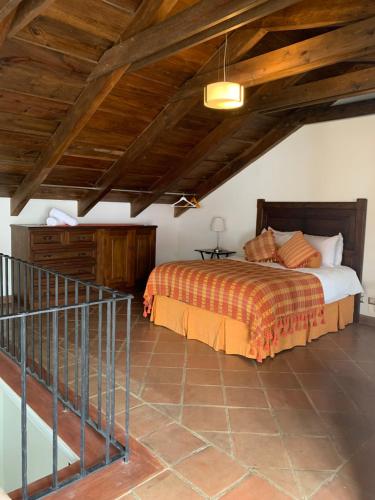 a bedroom with a bed and a wooden ceiling at Casa Anabel in Antigua Guatemala