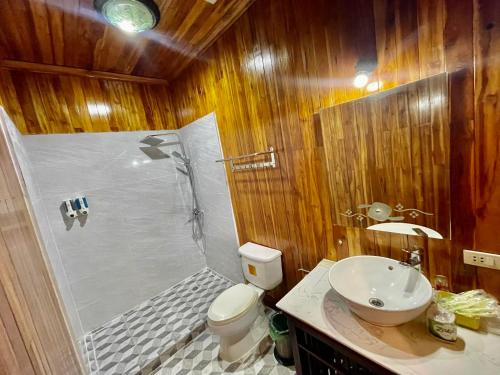 a bathroom with a shower and a toilet and a sink at Villa Phathana Boutique Hotel in Luang Prabang