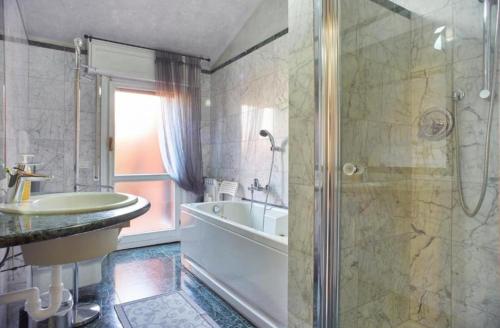 a bathroom with a tub and a sink and a shower at Residenza Fiera Verona in in Verona