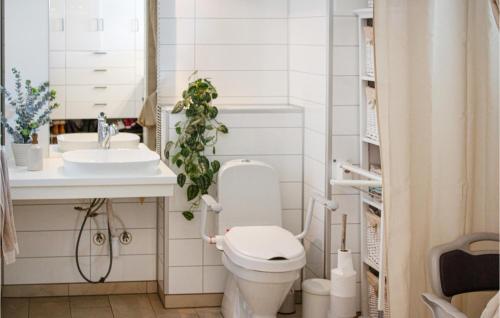 a bathroom with a toilet and a sink at Beautiful Home In Skien With Private Swimming Pool, Can Be Inside Or Outside in Skien