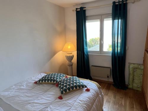 - une chambre avec un lit avec deux oreillers et une fenêtre dans l'établissement Appartement 2P, Rez-de-jardin, Accès Plage, Animaux OK, Parking, Internet Inclus - FR-1-487-355, à Cabourg