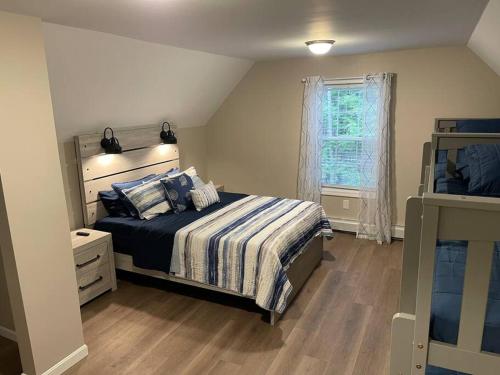 a bedroom with a bed and a window at Bungalow near Winnisquam Lake! Sleeps 14 in Sanbornton