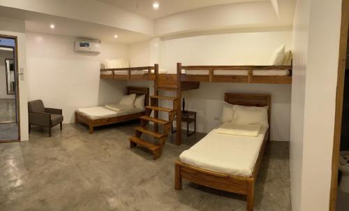 a room with two bunk beds and a desk at P&B Residences Legazpi in Legazpi