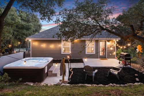 a backyard with a hot tub and a house at The Overlook Cottage . King Bed . Mini Lake View in Canyon Lake