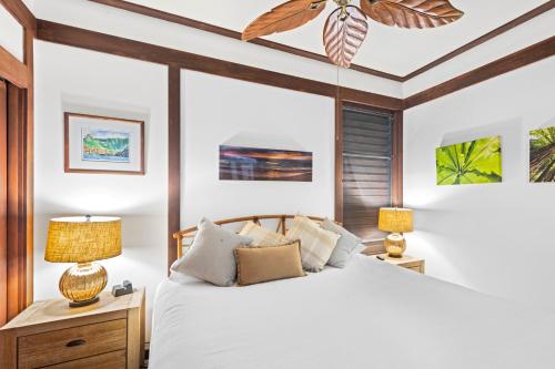 a bedroom with a white bed and two lamps at Oceanview 1BR at Kiahuna Plantation Unit 170 in Koloa
