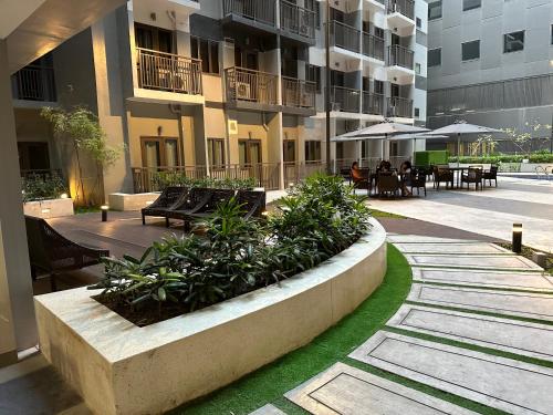 a courtyard of a building with benches and tables at S Residences Tower 3 MOA Luxe Staycation by C in Manila