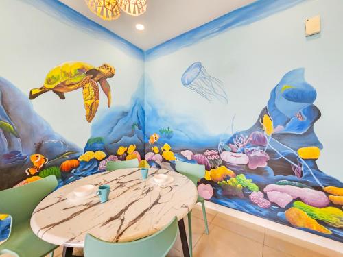 a dining room with a table and a ocean mural at D'Pristine Theme Suite by Nest Home at LEGOLAND in Nusajaya