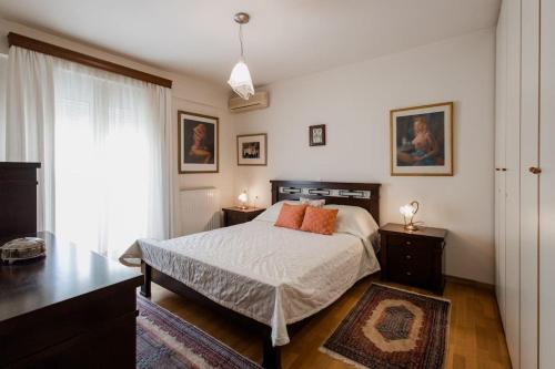 a bedroom with a bed and two night stands and a window at Dream Home - Heraklion Center in Heraklio