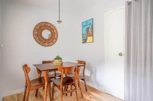 a dining room table with chairs and a mirror on the wall at Tranquil 2BR downtown condo, Parking, King bed in Seattle