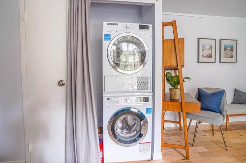 a washing machine in a room next to a door at Tranquil 2BR downtown condo, Parking, King bed in Seattle