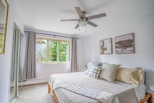 a bedroom with a bed and a ceiling fan at Tranquil 2BR downtown condo, Parking, King bed in Seattle