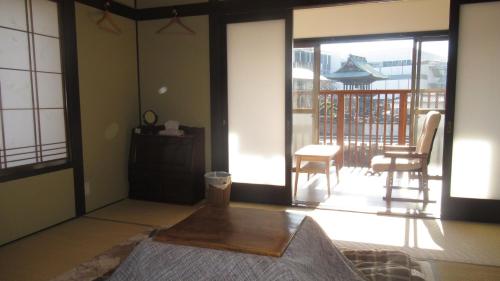a room with a bed and a sliding glass door at 松本はなれ Matsumoto HANARE - Japanese style private bedroom Guest hause in Matsumoto