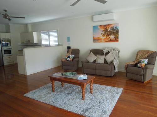 a living room with two couches and a coffee table at Oceanside Hawks Nest in Hawks Nest