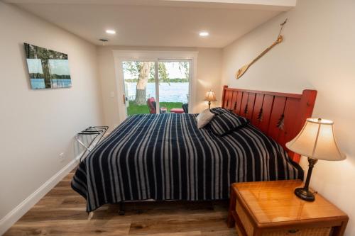 a bedroom with a bed with a striped comforter at Water's Edge Retreat 