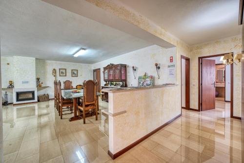a kitchen and living room with a table and chairs at Casa de Azzancha in Azinhaga