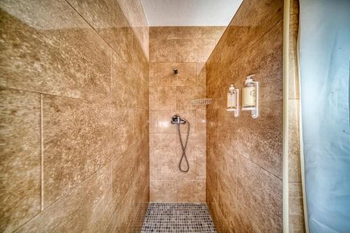 a bathroom with a shower with a tile floor at Casa de Azzancha in Azinhaga