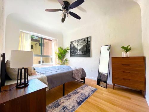 a bedroom with a bed and a ceiling fan at Heart of Hollywood Apartment - 2Bed 2Bath in Los Angeles